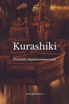 a boat sitting on top of a body of water next to a wooden structure with the words kurashiki probably japan's cutest town