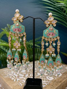 Hand painted meena jhumki style earring. Stone work and crystal bead work. Back and front side gold plated so long lasting color. Light weight and brass made. Silver foil Kundan. Turquoise Kundan Earrings For Wedding, Turquoise Temple Jewelry Earrings For Festivals, Turquoise Earrings For Wedding And Festivals, Turquoise Kundan Chandbali Earrings, Turquoise Kundan Earrings For Festivals, Turquoise Chandbali Earrings With Latkans, Turquoise Meenakari Temple Jewelry Earrings, Turquoise Meenakari Earrings For Wedding, Traditional Turquoise Earrings With Latkans