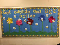 a bulletin board with flowers on it and the words get outside and active written in large letters