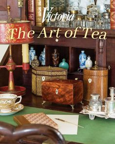 the cover of victoria's book, the art of tea is displayed on a table