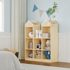 a child's bedroom with blue walls and wooden shelves filled with stuffed animals, toys and books