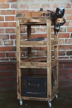 a wooden shelf with a pipe holder on top and a brick wall in the background