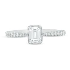 Sleek and chic, this sparkling diamond engagement ring appeals to her sophisticated sense of style. Crafted in 14K white gold, this exquisite design features a 1/2 ct. emerald-cut diamond wrapped in a shimmering frame of baguette-cut diamonds. Along the pinched shank, round diamonds in graduated sizes fortify the streamlined look. Radiant with 3/4 ct. t.w. of diamonds and a brilliant buffed luster, this engagement ring honours your bride-to-be. Due to the nature of pre-owned jewellery, the ring you choose may have been previously sized. Ring styles from our pre-owned jewelry inventory are sold at their current size and cannot be resized at purchase. As this inventory constantly changes, we are unable to state or guarantee the size of any pre-owned ring. White Emerald Cut Dazzling Diamond Ring, Dazzling White Emerald Cut Diamond Ring, Dazzling White Emerald-cut Diamond Ring, Emerald Cut Diamond Ring With Accents For Proposal, Promise Solitaire Baguette Cut Diamond Ring, Baguette Cut Solitaire Diamond Ring For Promise, Baguette Cut Solitaire Diamond Promise Ring, Fine Jewelry Solitaire Diamond Ring With Baguette Cut, Fine Jewelry Solitaire Baguette Cut Diamond Ring