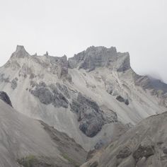 the mountains are covered in snow and clouds