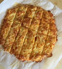 an uncooked pizza sitting on top of a piece of paper