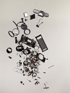 an assortment of electronic devices are scattered on top of each other in this artistic photo