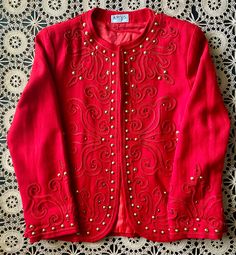 "Amazing, ruby red, embroidered bolero covered in gold studs and red rhinestones. Wonderfully, embellished blazer with gold, cone shaped studs along the neckline, waistline, sleeves, and pretty much all over. Cherry, red rhinestones add a touch of sparkle! In good vintage condition!! Normal vintage wear with some tiny holes. Tag Says: 8/fits like a S/M Label: Raffles Measurements taken while lying flat: Pit to pit: 18\" Shoulder to shoulder: 15 1/2\" Top to bottom: 23 1/2\"  Waist: 21\"  Sleeve Winter Embellished Long Sleeve Blazer, Spring Embellished Fitted Blazer, Fitted Outerwear For Holiday Festivities, Vintage Red Party Blazer, Fall Festive Outerwear With Gold Embroidery, Embellished Fitted Blazer With Long Sleeves, Festive Fall Outerwear With Gold Embroidery, Fitted Embellished Long Sleeve Blazer, Festive Embellished Fitted Blazer