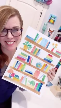 a woman holding up a poster with books on it