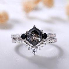 an engagement ring with black and white diamonds