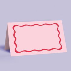 a pink card with a red scallop border on it and a blue background