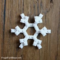 a snowflake made out of legos sitting on top of a wooden table