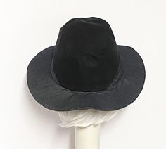 Fedora hat, light weight grey denim with a black cotton twill contrast, 1" cotton band inside, the hat has crown 3 1/2 " in length, lined in a rayon print and a one piece 3" brim. One size fits most up to 23" Machine wash / hand dry Made in USA Whats great is this hat is packable all you need to do is steam or press to look good as new. Black Fitted Bucket Hat, Gray Curved Brim Hat For Kentucky Derby, Gray Brimmed Hat For Kentucky Derby, Fitted Black Panama Hat With Curved Brim, Adjustable Charcoal Hat With Curved Brim, Gray Brimmed Cotton Hat, Classic Cotton Fedora With Curved Brim, Gray Fitted Wide Brim Fedora, Black Reversible Hat With Curved Brim