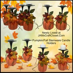 several pumpkin themed candlesticks with leaves and flowers on them, all decorated in different colors