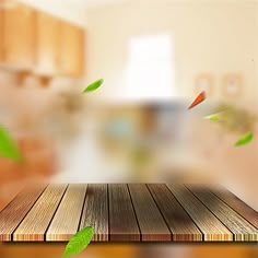 a wooden table with leaves flying over it