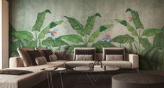 a living room with a couch, table and wall mural on the wall behind it