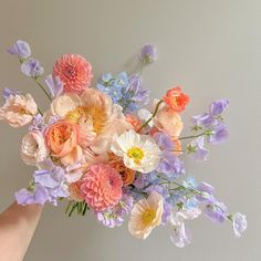 a person holding a bouquet of flowers in their hand