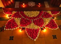 a decorated table with candles and flowers on the floor for diwaling or decorating