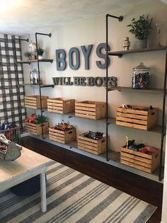 a room filled with lots of wooden boxes and shelves next to a wall mounted sign that says boys will be boys