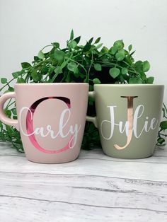 two coffee mugs sitting next to each other