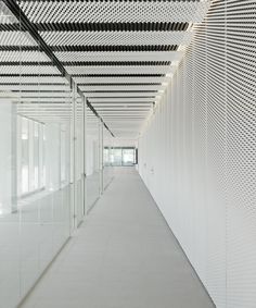 an empty hallway with white walls and ceiling