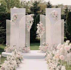 an outdoor ceremony setup with white and pink flowers