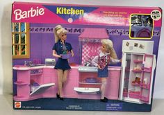 the barbie kitchen is pink and has two dolls in it's cabinets, one with a stove and sink