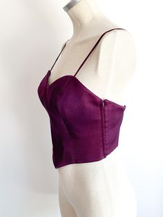 Delicious, regal dark violet fitted bustier with straps. Side zips. A rare, nearly perfect thing of beauty. Made in Italy. Fabric: Wool with acetate liningLabel: Moschino CoutureFit: SEra: 1990’s Measurements: Bust 34"Under bust 27"Between straps 9" Length (side) 7"Strap drop (shoulder to top) 6" Condition: Very good. One strap is twisted (i.e. doesn't lay flat) and one small hole in front outer covering (see photo). Party Underbust Bodice With Straps, Fitted Bodice With Spaghetti Straps And Lined, Elegant Fitted Purple Corset, Elegant Corset With Adjustable Straps For Party, Elegant Party Corset With Adjustable Straps, Party Bodice With Built-in Bra And Fitted Design, Party Bodice With Straps And Sleeveless Design, Evening Bodice With Built-in Bra, Fitted Sleeveless Bodice For Formal Occasions