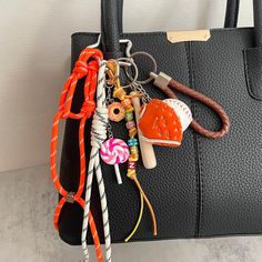 a handbag with various items attached to it