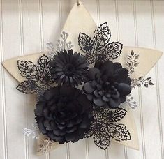 a star shaped decoration with black flowers on it