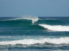 a large wave is breaking in the ocean