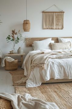 a bed with white linens and pillows in a small room next to some plants