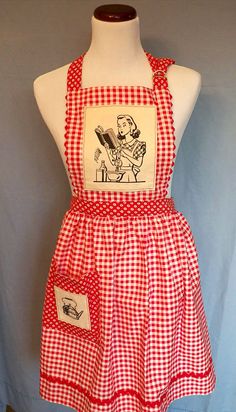 a red and white checkered apron on a mannequin with an image of a woman reading