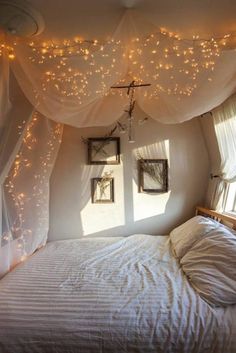 a bed with lights hanging from the ceiling