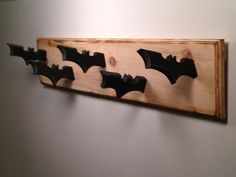 three bats are mounted on the wall