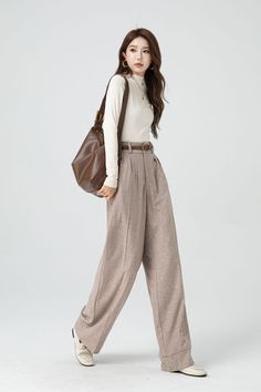 With its timeless silhouette and luxurious feel, this womens bespoke high waist wide leg wool pants is a true investment piece that will elevate any outfit to new levels of refinement and class. DETAIL * 30% wool, 30% fiber, 40% polyester * Fully satiny lining, more nice to the touch body * Two side seam pockets * Front button and zipper closure * Maxi wool pants * Wide leg wool pants * Loose wool pants * Daily casual pants * For autumn and winter * Dry clean * Belt not for sale * Lean More abou Chic High Waist Wool Wide Leg Pants, Chic High Waist Wide Leg Wool Pants, Classic High Waist Wool Wide Leg Pants, High Waist Wool Wide Leg Pants For Work, Fall Wool Wide Leg Pants, Elegant High Waist Wool Dress Pants, Wool Pants Women, Chic High-waist Wool Wide Leg Pants, Winter High-waisted Wide Leg Pants