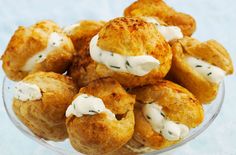 a glass bowl filled with fried food on top of a blue tablecloth covered floor