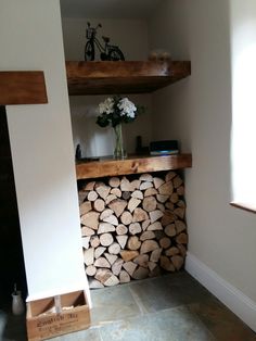 a stack of firewood sitting on top of a wooden floor