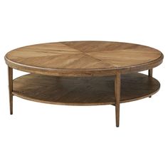 a round wooden table with two shelves on the bottom and one shelf below it that is holding a coffee table