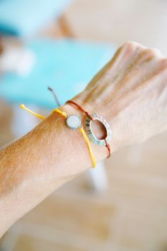 This is a Beach Sand slide knot bracelet. It is made with the white sand from the #1 beach in the US, Siesta Key Beach Florida This sand charm is a mini size for more of a petite looking bracelet.  This bracelet is on a yellow waxed polyester cording, the same as the pura vida bracelets. The charm is stainless steel. They give a great beachy look stacked with other cord bracelets! These bracelets looks amazing as a bikini accessory at the beach! It's light weight and easily adjusts to any size. Please see all my cording bracelets. I have many color combinations to choose from. Feel free to ask questions.  Thanks for looking! Live in an ocean state of mind... every single day. Silver Friendship Bracelets For Beach In Summer, Summer Beach Silver Friendship Bracelets, Silver Friendship Bracelets For Summer Beach, Bohemian Silver Friendship Bracelets For Beach, Silver Bohemian Friendship Bracelets For Beach, Bohemian Silver Friendship Bracelet For Beach, Adjustable Beachy Silver Jewelry, Beachy Adjustable Silver Jewelry, Resizable Silver Friendship Bracelets For Beach