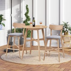 a table with two stools and a bottle of wine