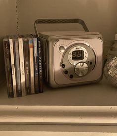 a radio sitting on top of a shelf next to books