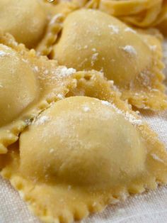 some ravioli with powdered sugar on top are sitting on a towel and it is ready to be eaten