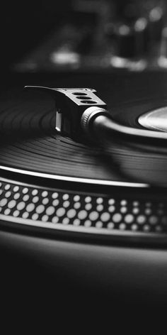 an old record player with its turntable spinning on it's side in black and white