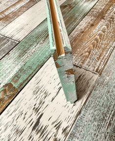 a wooden floor with white and green paint