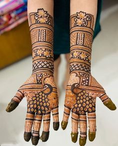 a woman's hands decorated with hennap and designs on her hand,