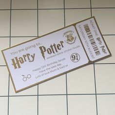 a harry potter ticket sitting on top of a tiled floor