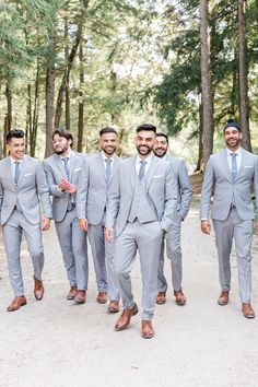 a group of men in grey suits and ties