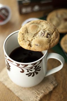 a cookie being dipped into a cup of coffee