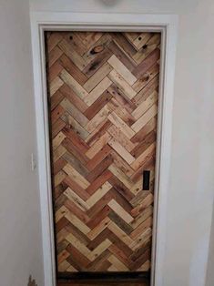 a door made out of wooden planks with a clock on the wall above it