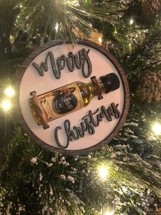 a merry christmas ornament hanging on a tree